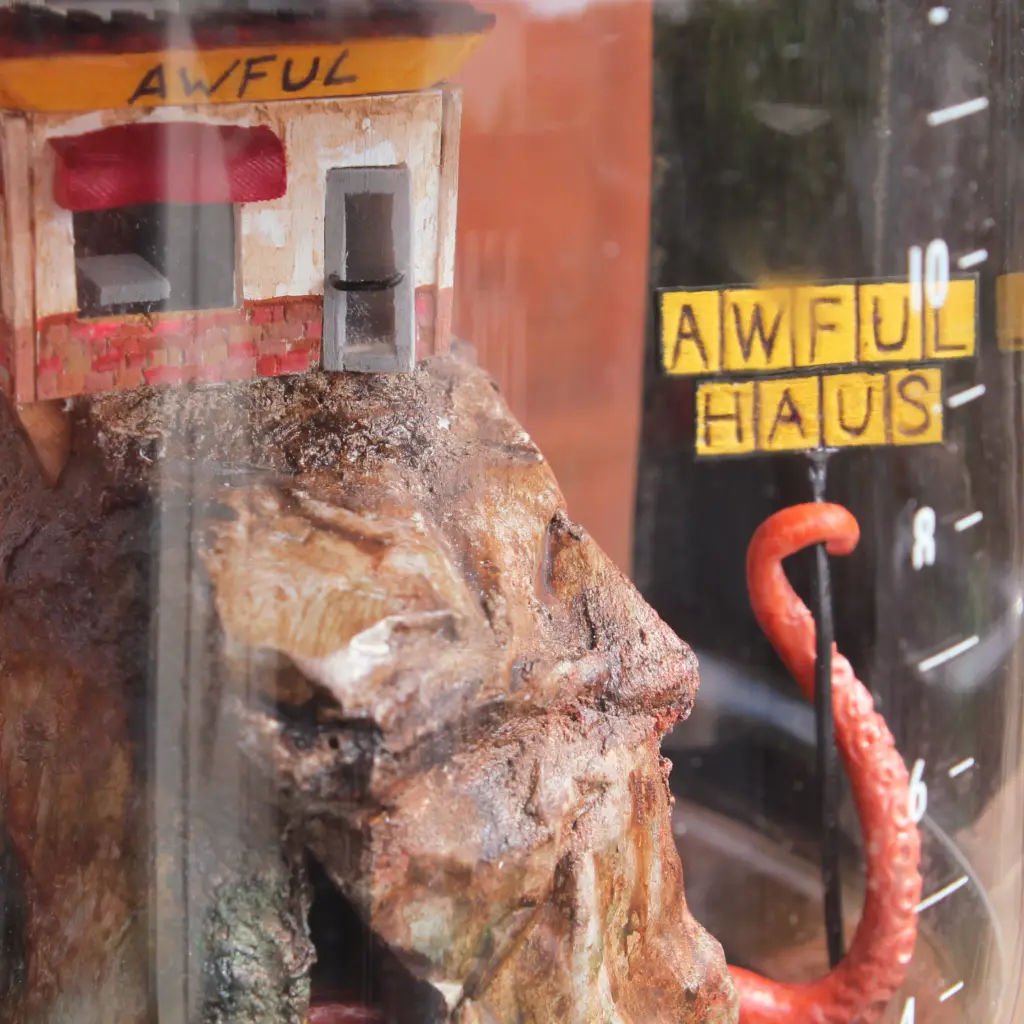 Detail shot of octopus tentacle, sign, and diner
